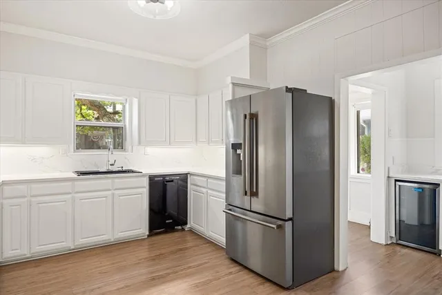 a kitchen with stainless steel appliances a refrigerator and a sink