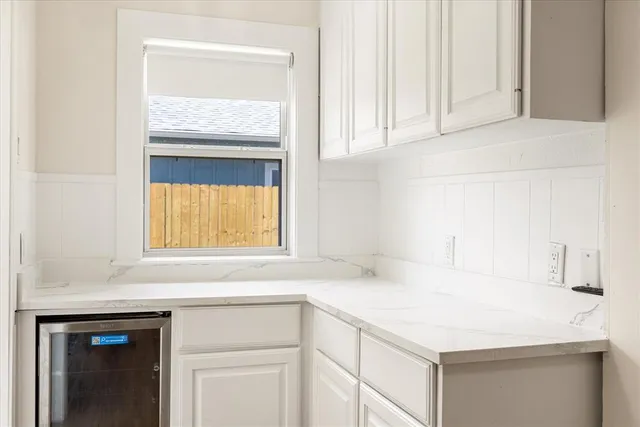 a kitchen with a sink cabinets and a window