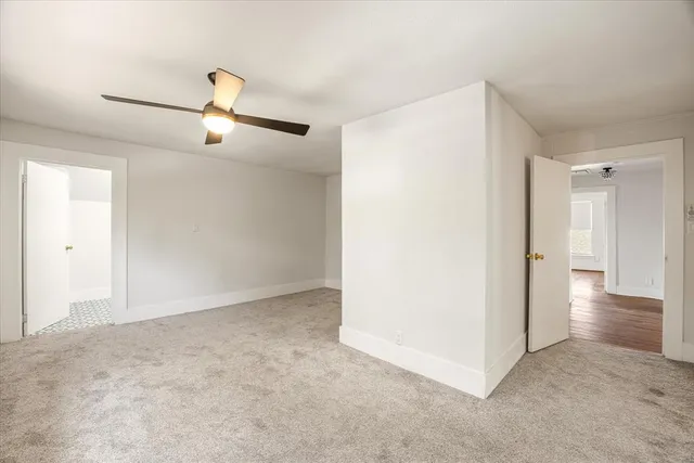 a view of an empty room and wooden floor
