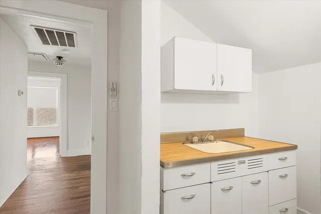 a view of cabinets and wooden floor