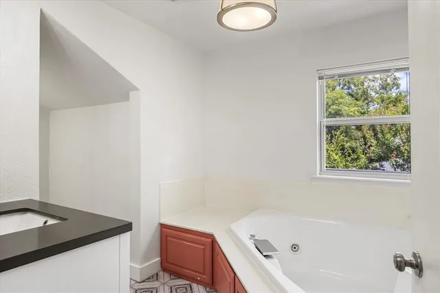 a bathroom with a granite countertop sink toilet and bathtub