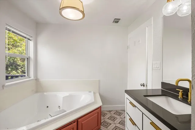a bathroom with a sink a toilet and bathtub