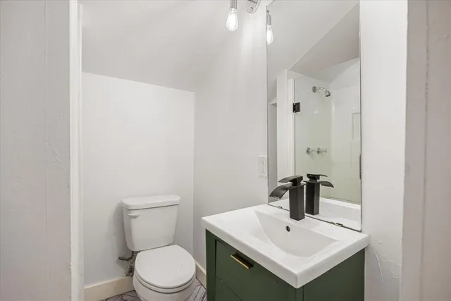 a white toilet sitting next to a bathroom sink