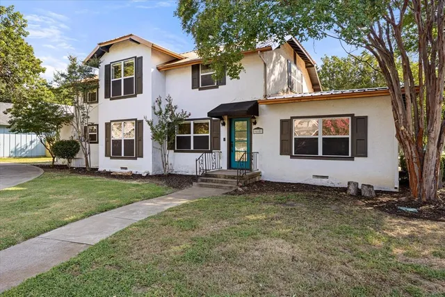a front view of a house with a garden