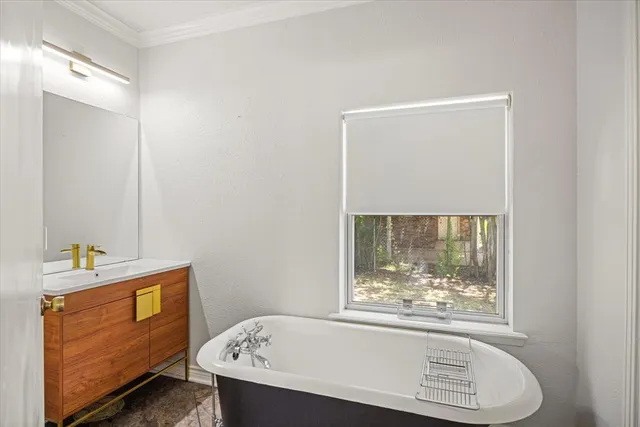 a bathroom with a bathtub and a window