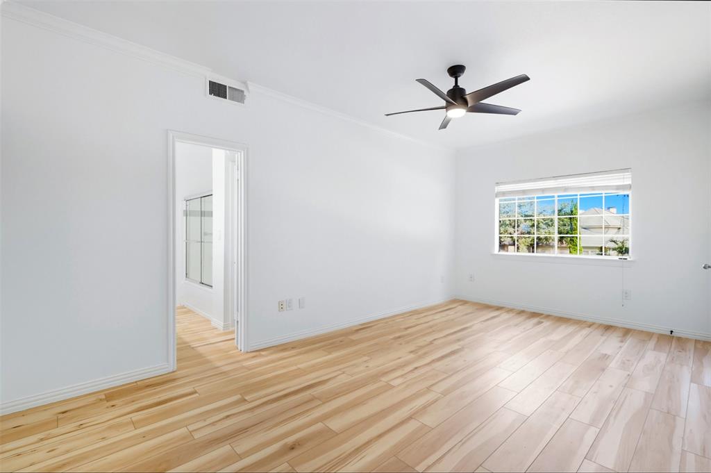 2601 Preston Road, Unit 1201 Plano, TX 75093 - Photo 9 of 28 a view of an empty room with wooden floor and a window