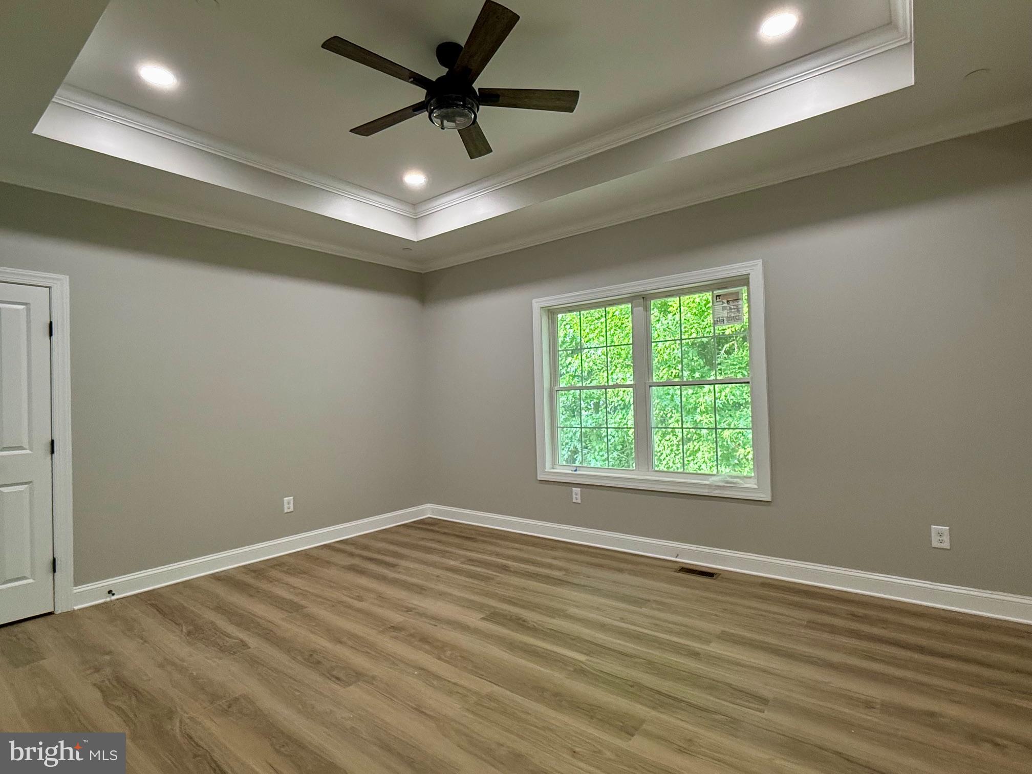 17480 Lighthouse Commons Drive Piney Point, MD 20674 - Photo 13 of 23 an empty room with wooden floor and windows