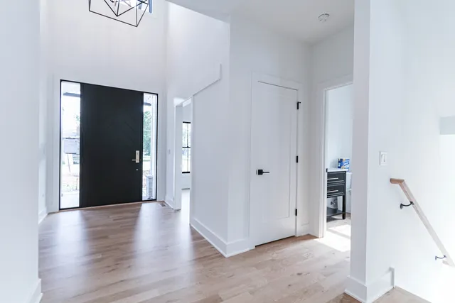 a view of a hallway with wooden floor