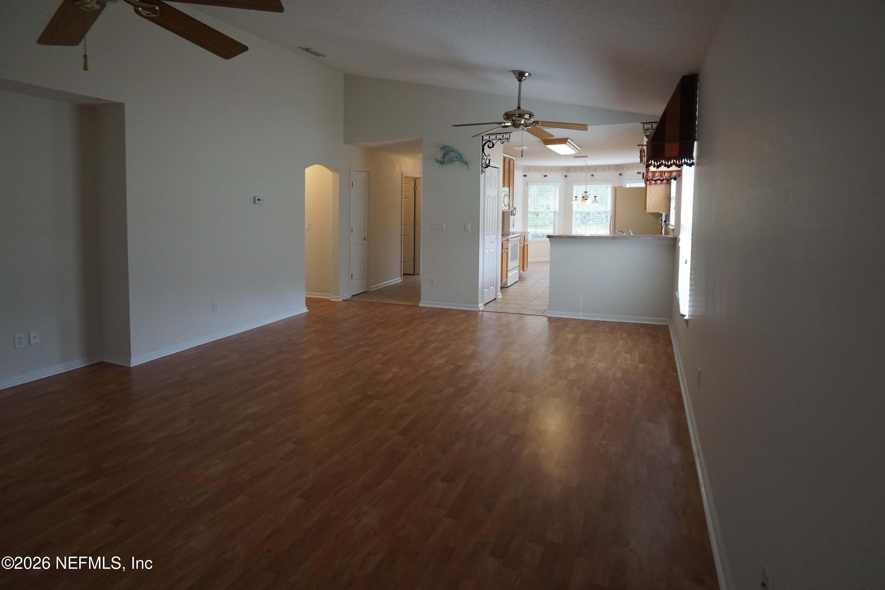 1721 Keswick Road St. Augustine, FL 32084 - Photo 7 of 17 a view of a kitchen with wooden floor and a ceiling fan