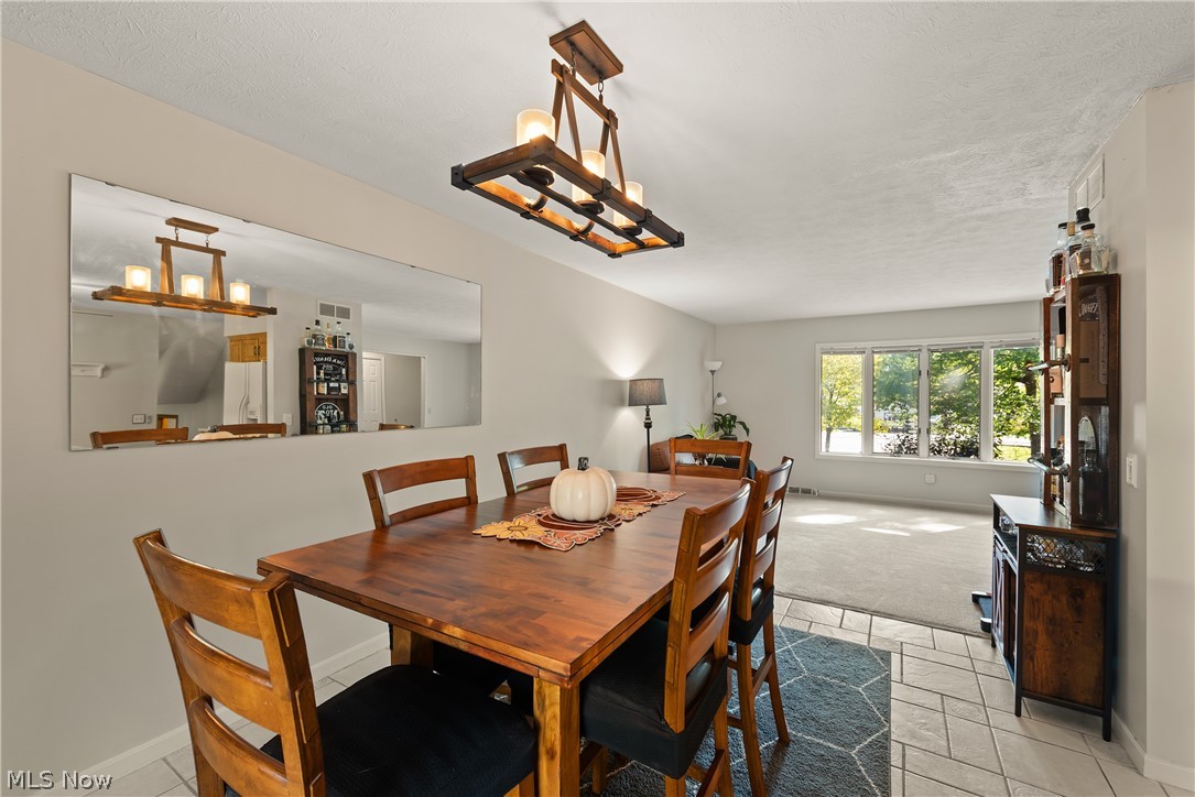 75 Houghton Road Northfield, OH 44067 - Photo 15 of 48 Dining area with a coffered ceiling and a multi-light chandelier