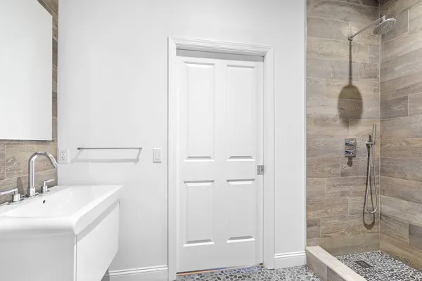a bathroom with a shower sink and mirror