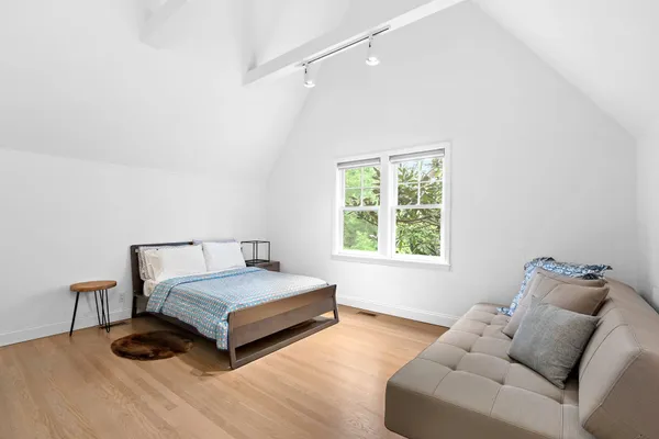 a bedroom with a bed and a window