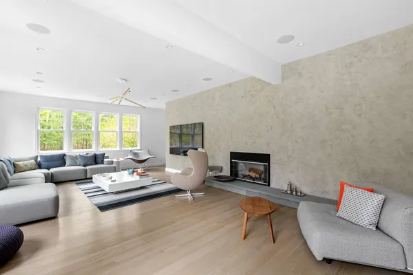 a living room with furniture wooden floor and a fireplace