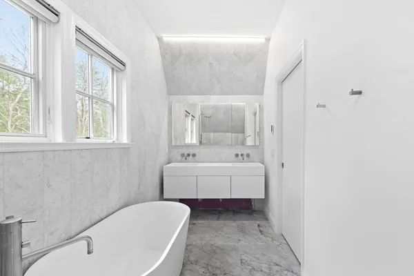 a bathroom with a sink a toilet and bathtub