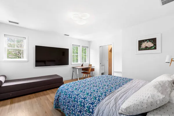 a bedroom with a bed and a flat screen tv