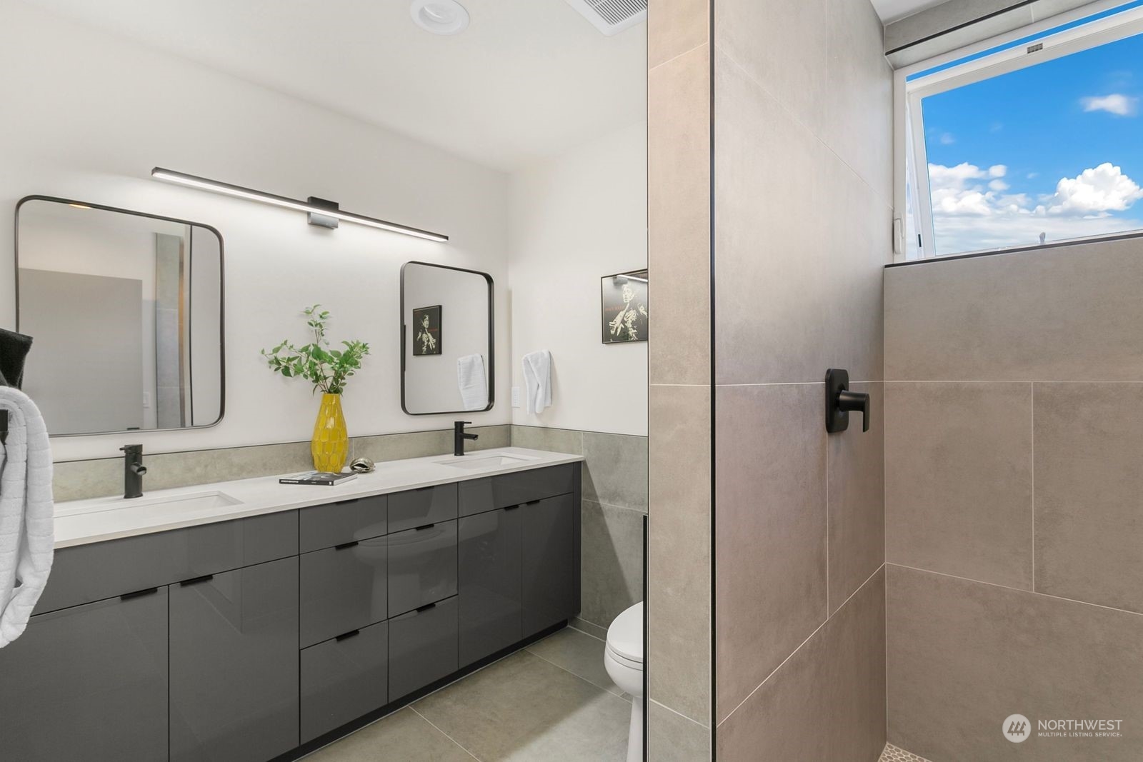 729 South Southern Street Seattle, WA 98108 - Photo 22 of 29 a bathroom with a double vanity sink and mirror