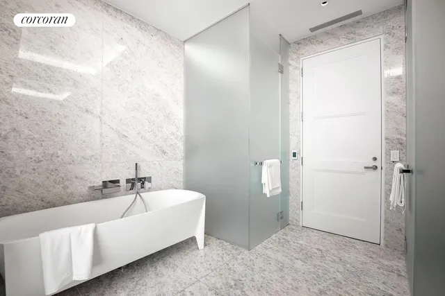 a spacious bathroom with double vanity and a shower