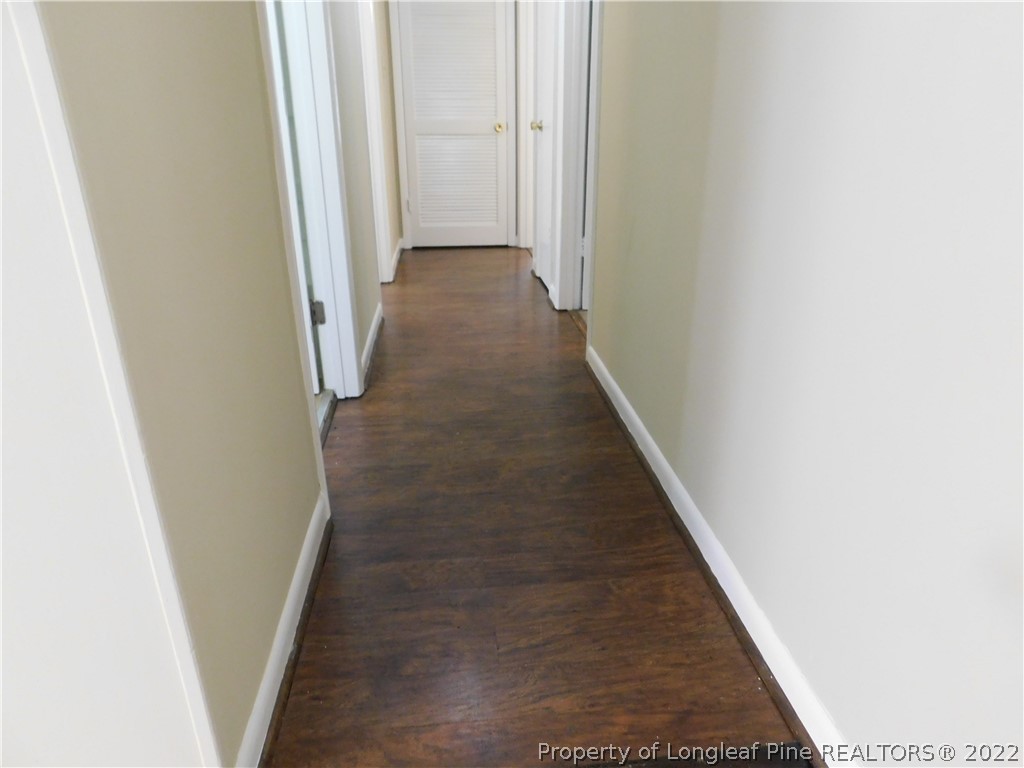 4451 Ruby Road Fayetteville, NC 28311 - Photo 2 of 14 a view of a hallway with wooden floor
