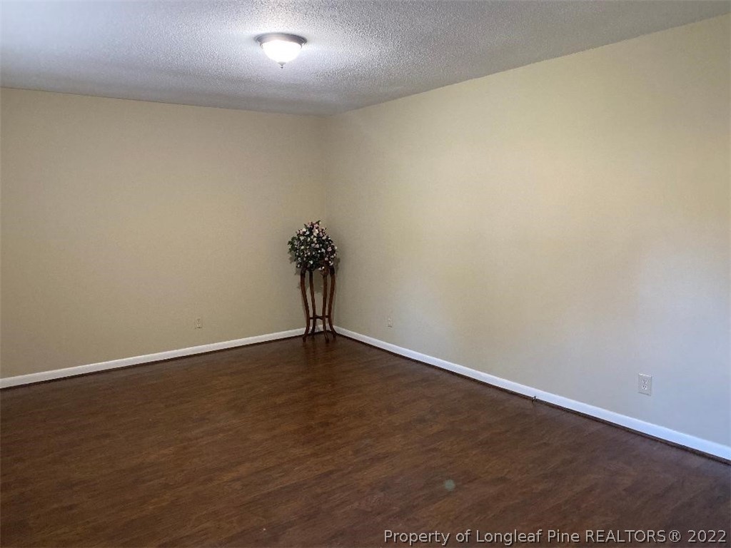 4451 Ruby Road Fayetteville, NC 28311 - Photo 4 of 14 an empty room with wooden floor