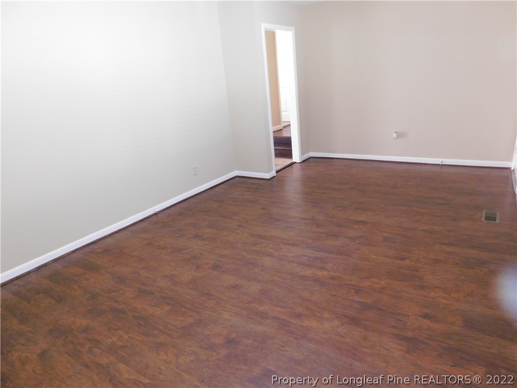 4451 Ruby Road Fayetteville, NC 28311 - Photo 5 of 14 an empty room with wooden floor