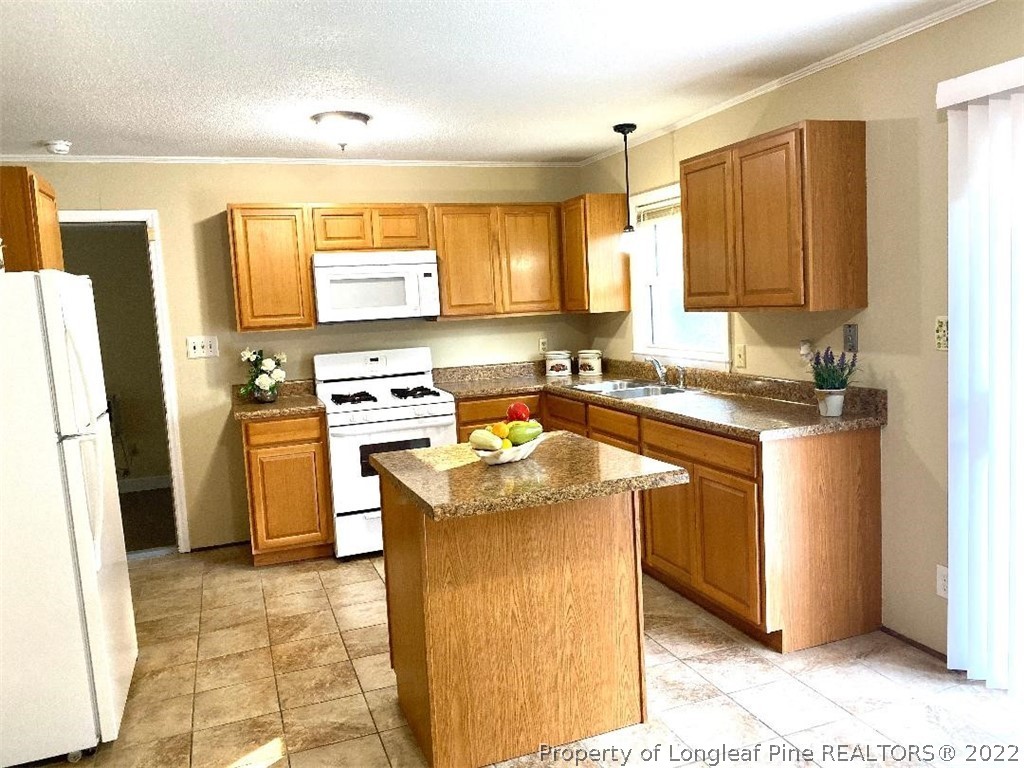 4451 Ruby Road Fayetteville, NC 28311 - Photo 6 of 14 a kitchen with a sink stove top oven and refrigerator