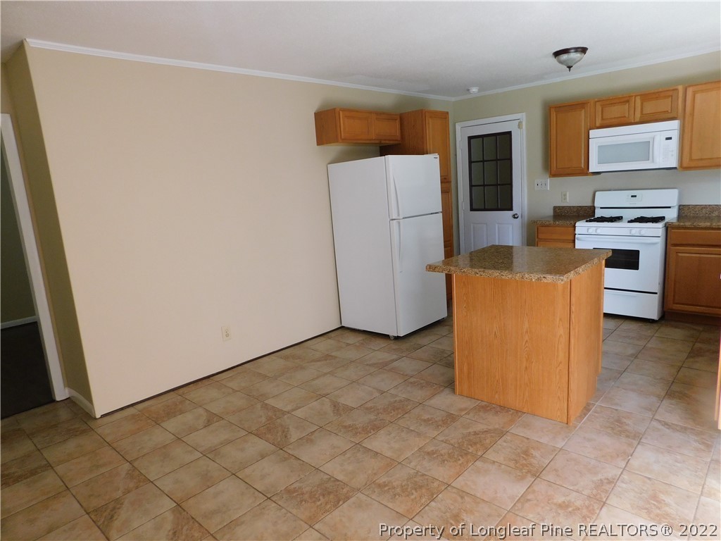 4451 Ruby Road Fayetteville, NC 28311 - Photo 8 of 14 a view of kitchen with stainless steel appliances a refrigerator and a stove top oven