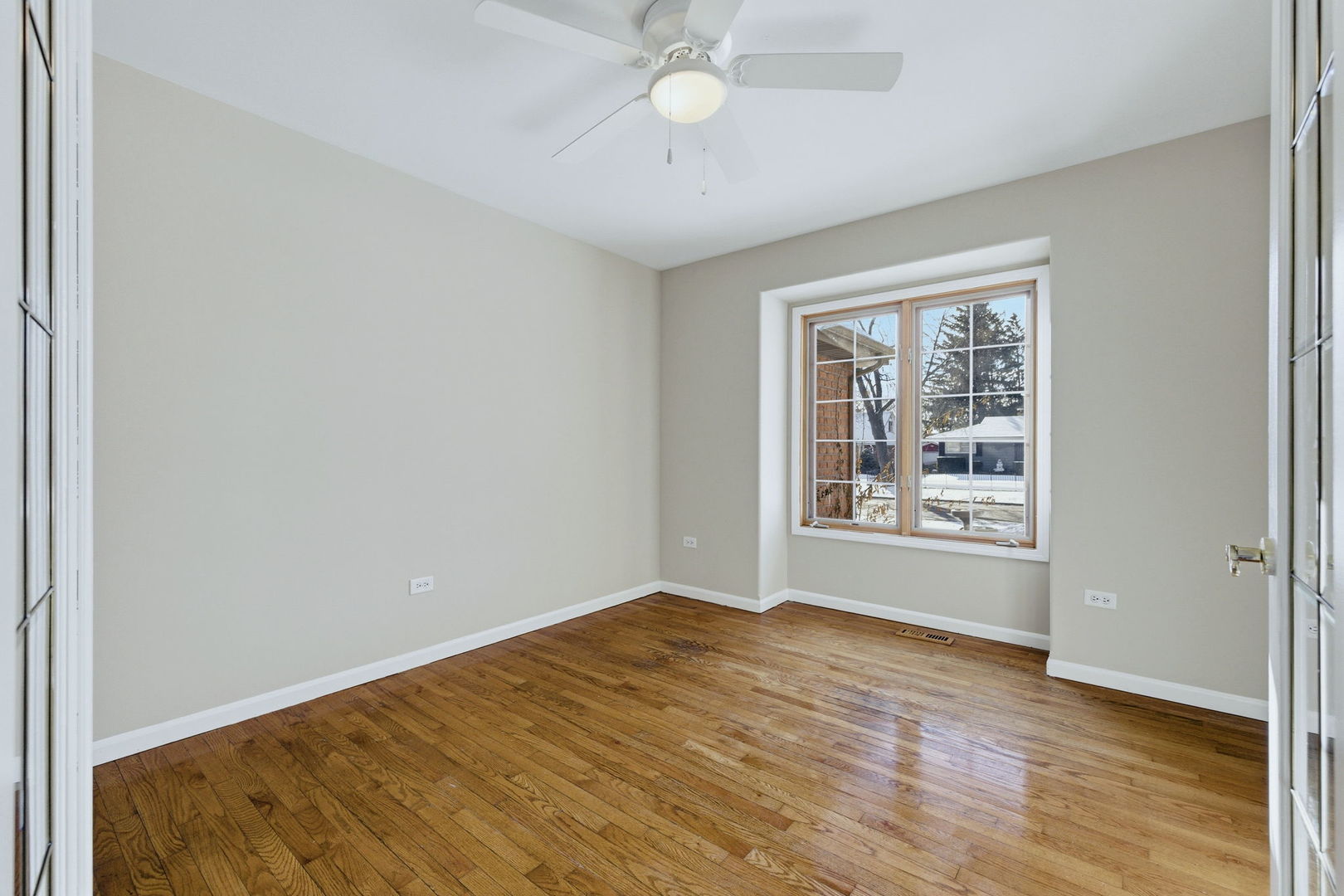 1305 Campbell Street Joliet, IL 60435 - Photo 12 of 34 an empty room with wooden floor and windows