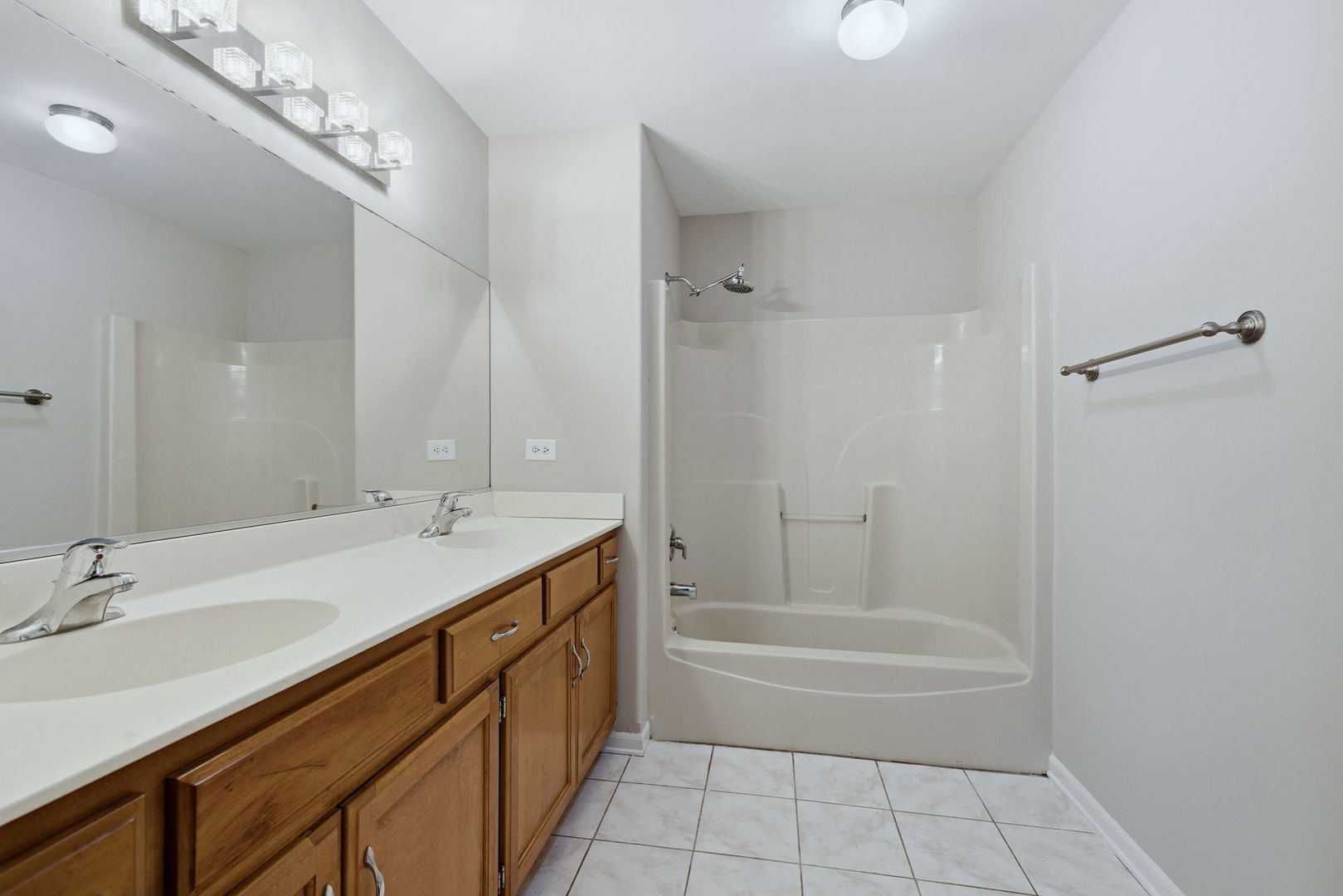 1305 Campbell Street Joliet, IL 60435 - Photo 21 of 34 a bathroom with a tub sink double vanity and a mirror