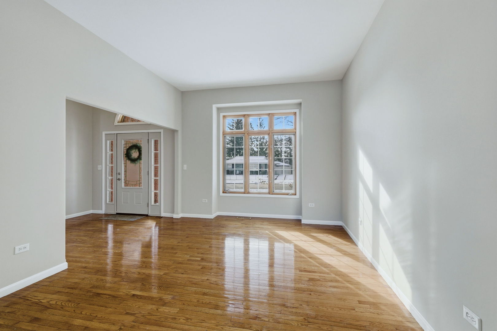 1305 Campbell Street Joliet, IL 60435 - Photo 4 of 34 a view of an empty room with window and wooden floor