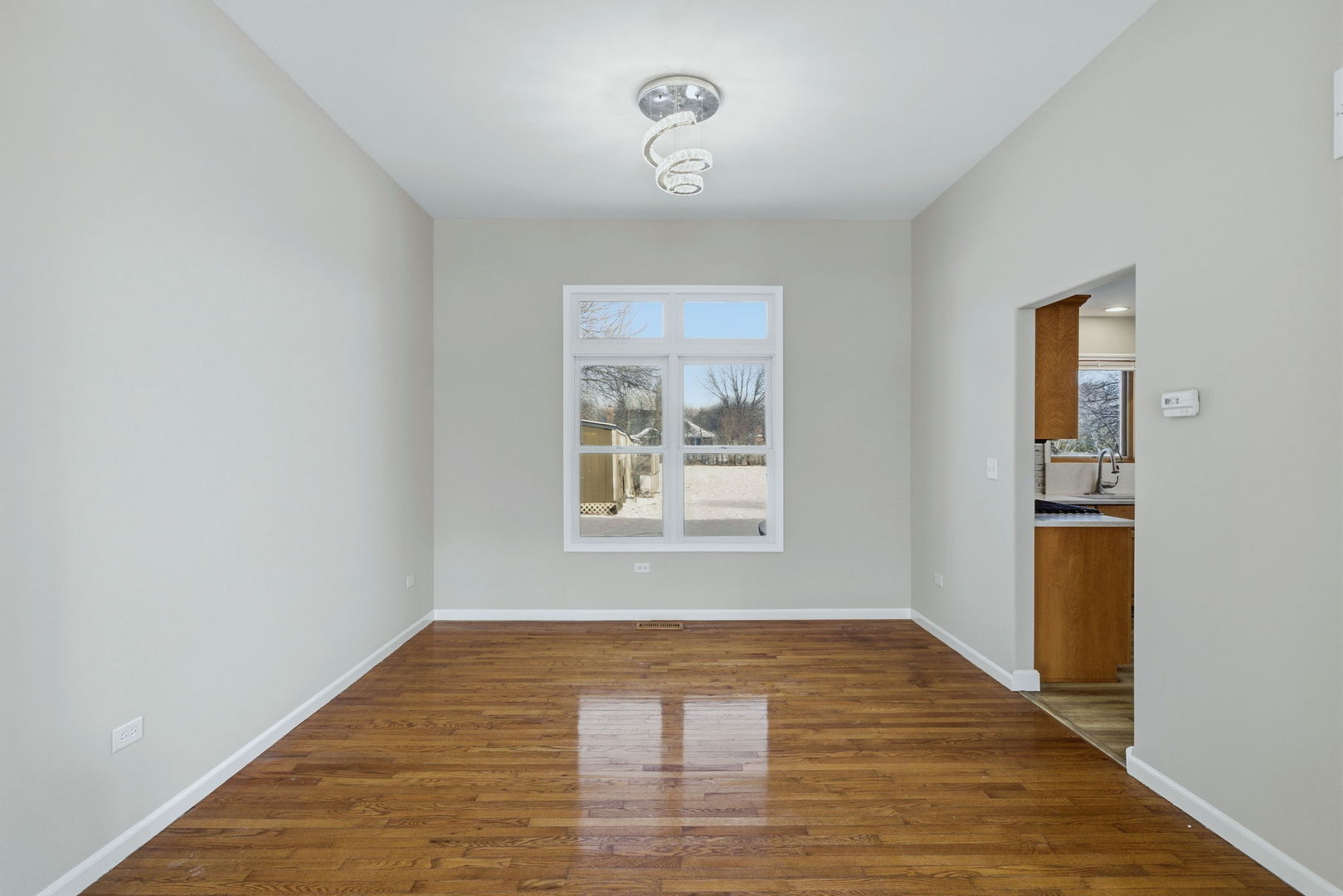 1305 Campbell Street Joliet, IL 60435 - Photo 5 of 34 a view of an empty room with window and wooden floor