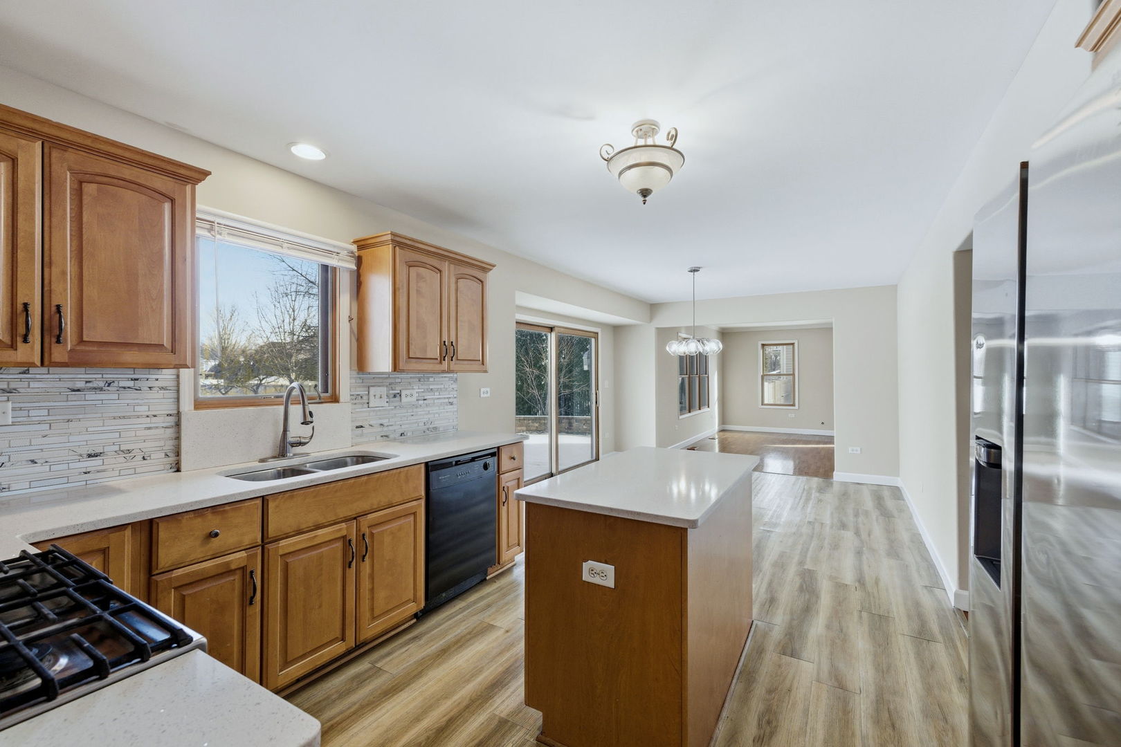 1305 Campbell Street Joliet, IL 60435 - Photo 7 of 34 a kitchen with stainless steel appliances granite countertop a sink stove and refrigerator