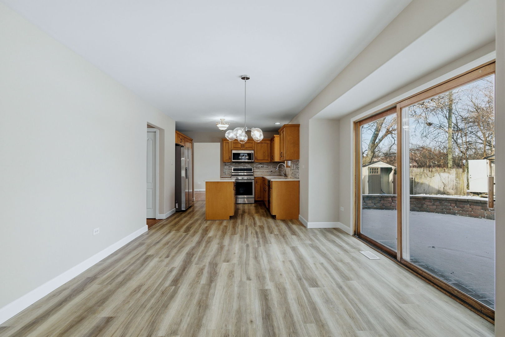 1305 Campbell Street Joliet, IL 60435 - Photo 9 of 34 a view of a kitchen with wooden floor and electronic appliances