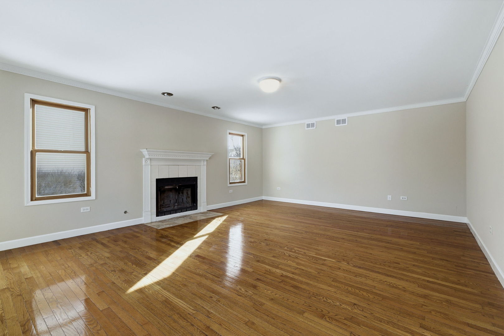 1305 Campbell Street Joliet, IL 60435 - Photo 10 of 34 a view of an empty room with wooden floor and a window