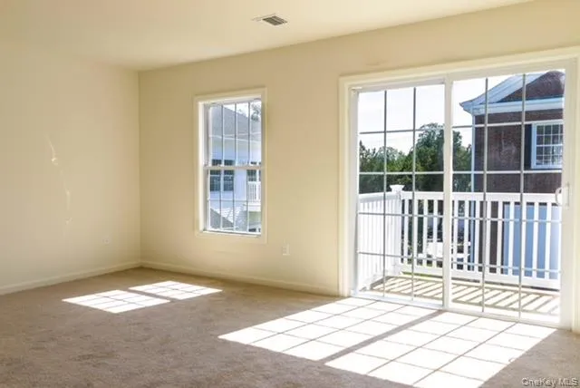 a view of a bedroom with wooden floor and a window