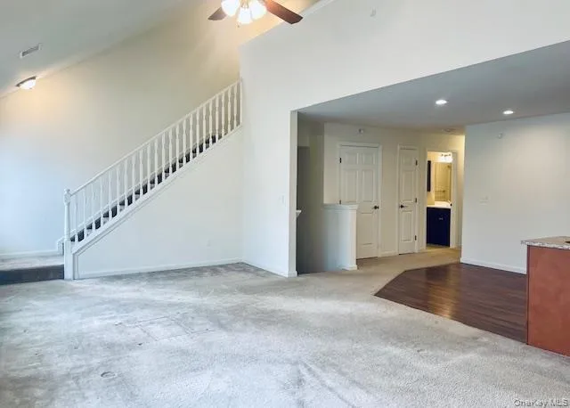 a kitchen with granite countertop a refrigerator stove and microwave