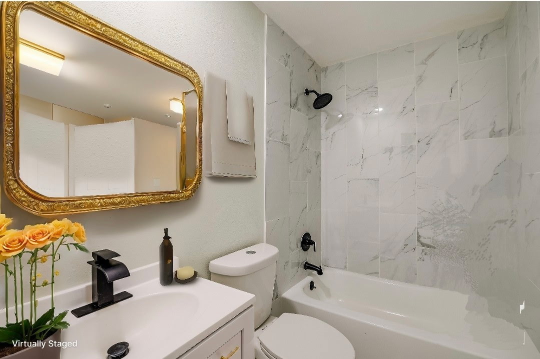 7004 Craybrough Circle Austin, TX 78724 - Photo 3 of 19 Marble-tiled shower and sleek vanity create a refreshing personal retreat.