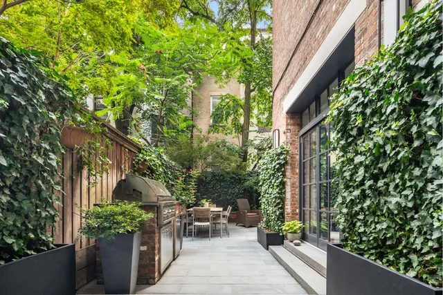 a view of a kitchen with granite countertop a sink and a refrigerator