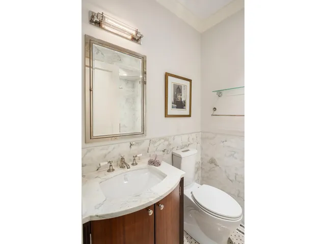 a large kitchen with granite countertop a stove a sink a window and living room view