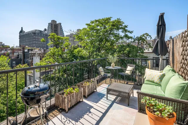 a living room with furniture and a book shelf