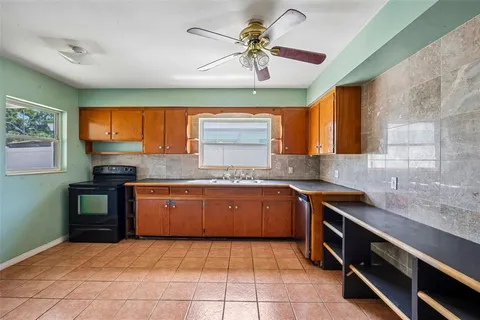 a kitchen with stainless steel appliances granite countertop a sink and cabinets