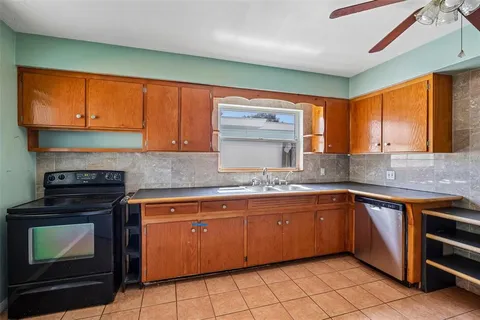 a kitchen with stainless steel appliances a stove sink and cabinets