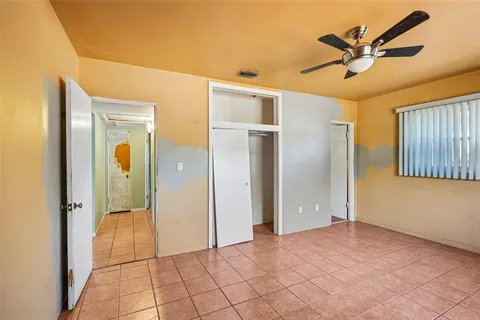 a view of a livingroom with a chandelier fan and closet