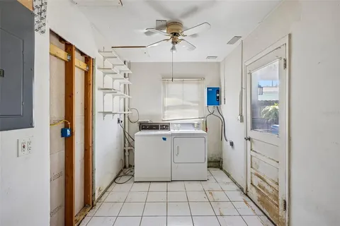 a room with white cabinets and white appliances