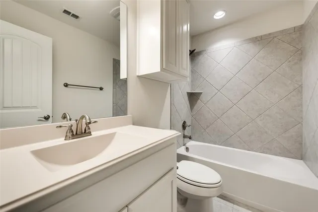 a bathroom with a sink a toilet and a bathtub
