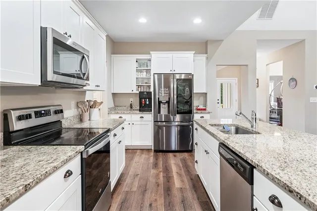 a bathroom with a granite countertop sink toilet and a mirror