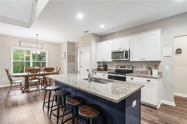 a bathroom with a granite countertop sink a toilet and a mirror