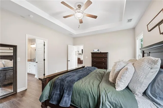 a bedroom with furniture and a wooden floor