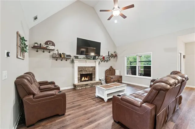 a kitchen with a stove a sink dishwasher a dining table and chairs with wooden floor