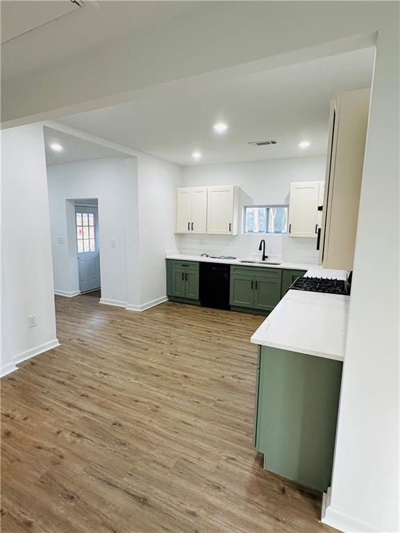 25 4th Street Gainesville, GA 30504 - Photo 11 of 20 a large kitchen with kitchen island a sink dishwasher stove with cabinets and wooden floor