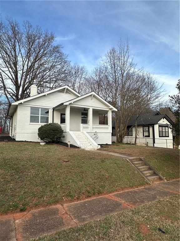 25 4th Street Gainesville, GA 30504 - Photo 2 of 20 a view of a yard in front of a house with a large tree